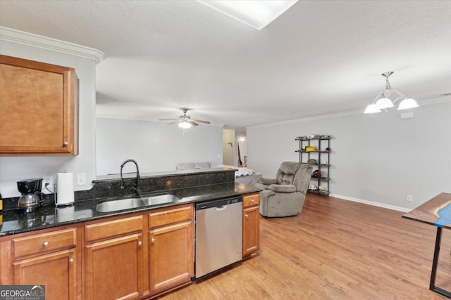 kitchen featuring brown cabinets, ceiling fan with notable chandelier, stainless steel dishwasher, light wood-style floors, and a sink