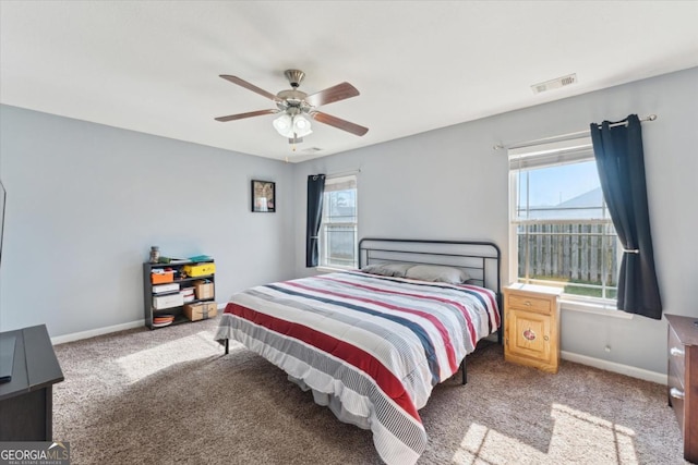 bedroom featuring visible vents, carpet flooring, and baseboards