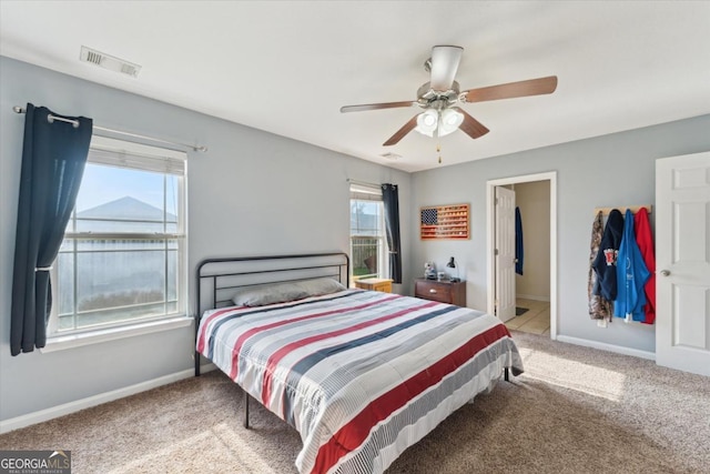 bedroom featuring visible vents, baseboards, carpet, and ceiling fan