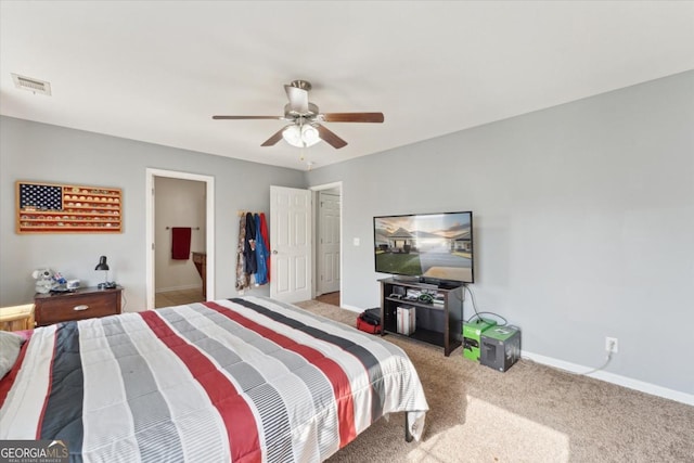 carpeted bedroom with visible vents, baseboards, and a ceiling fan