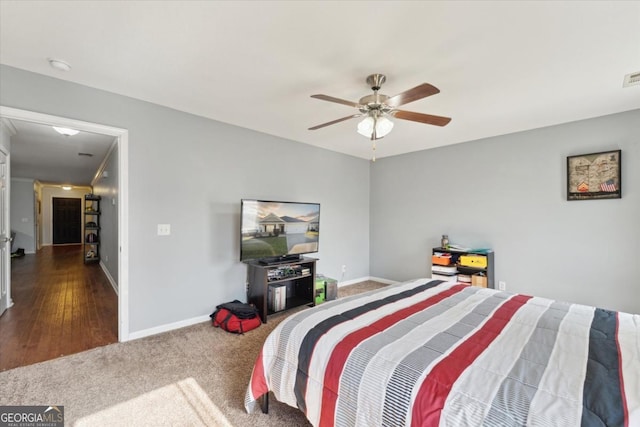 carpeted bedroom featuring visible vents, a ceiling fan, and baseboards