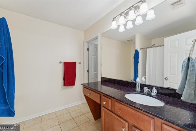 full bath with vanity, a shower with shower curtain, visible vents, baseboards, and tile patterned flooring