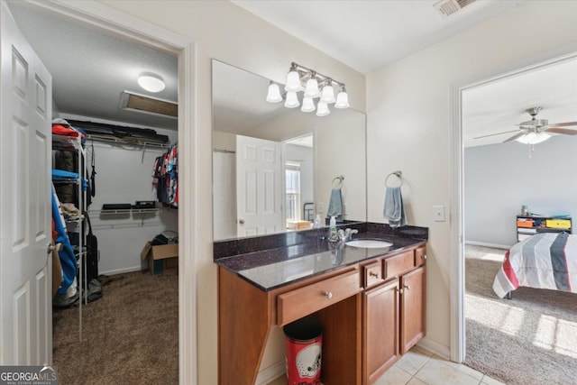 bathroom with a walk in closet, visible vents, a ceiling fan, tile patterned flooring, and vanity