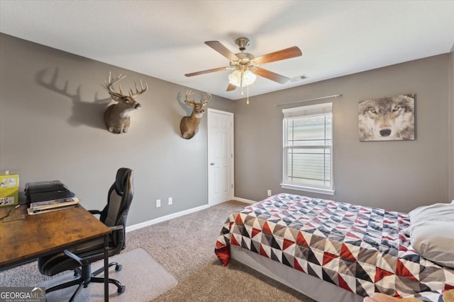 bedroom featuring visible vents, baseboards, carpet, and a ceiling fan