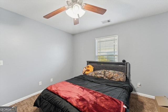 bedroom featuring a ceiling fan, carpet, visible vents, and baseboards