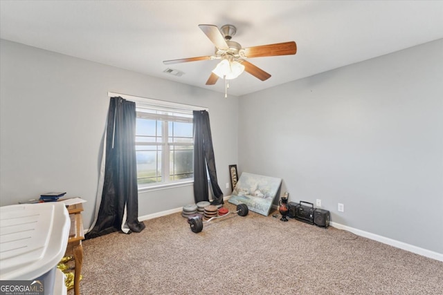 miscellaneous room featuring visible vents, baseboards, ceiling fan, and carpet flooring