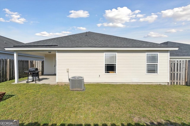 rear view of house featuring a patio area, a lawn, and a fenced backyard