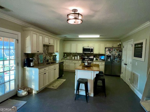 kitchen featuring visible vents, ornamental molding, a sink, appliances with stainless steel finishes, and tasteful backsplash