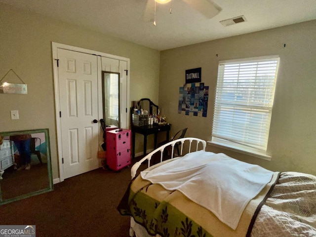 bedroom with visible vents, carpet, a closet, and a ceiling fan