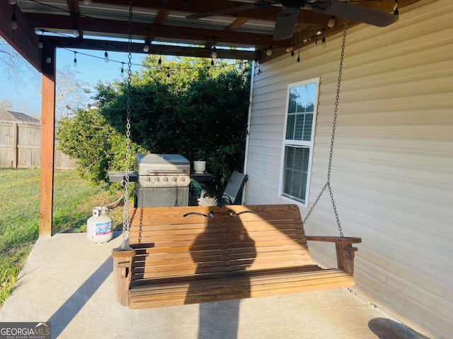 deck featuring fence, a lawn, a patio area, area for grilling, and a ceiling fan