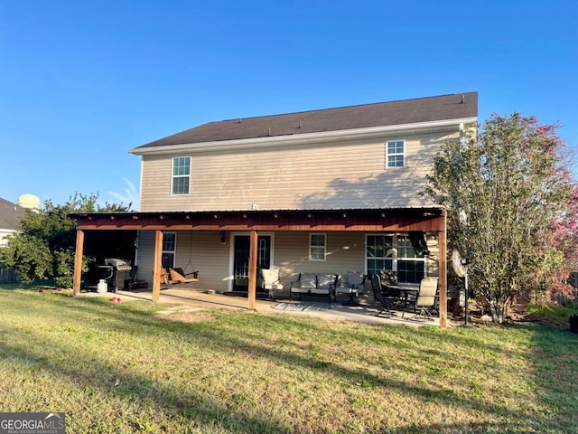 rear view of property featuring a yard and a patio