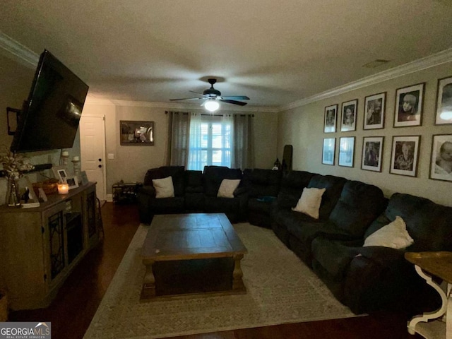 living room with crown molding, wood finished floors, and a ceiling fan