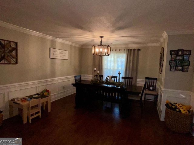 dining room featuring an inviting chandelier, crown molding, a wainscoted wall, and a textured ceiling