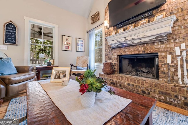 4770 Hilltop Dr NW, Acworth, GA 30101 - living area with lofted ceiling, wood finished floors, a brick fireplace, and ceiling fan
