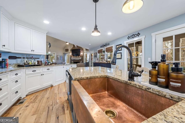 4770 Hilltop Dr NW, Acworth, GA 30101 - kitchen featuring healthy amount of natural light, light wood-style floors, white cabinetry, hanging light fixtures, and lofted ceiling