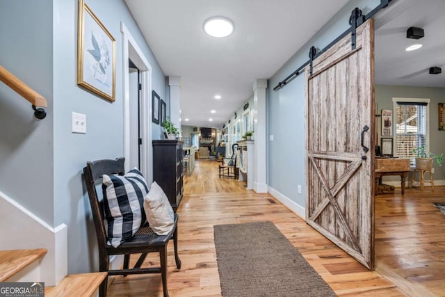 4770 Hilltop Dr NW, Acworth, GA 30101 - hall with a barn door, light wood-style flooring, and healthy amount of natural light