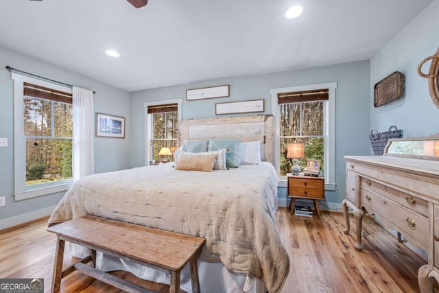 4770 Hilltop Dr NW, Acworth, GA 30101 - bedroom with multiple windows, light wood finished floors, and recessed lighting