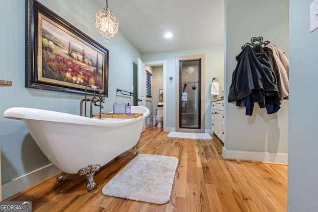 4770 Hilltop Dr NW, Acworth, GA 30101 - bathroom with a shower stall, wood finished floors, a soaking tub, recessed lighting, and a chandelier