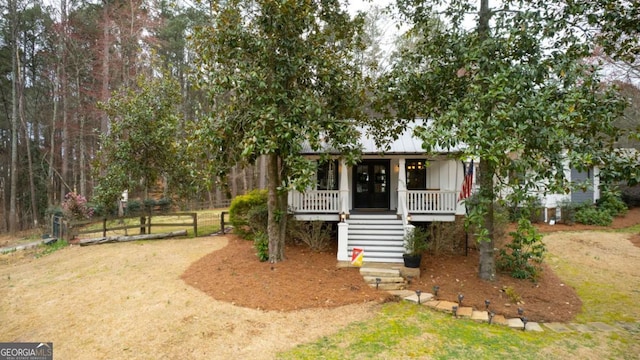 4770 Hilltop Dr NW, Acworth, GA 30101 - view of property hidden behind natural elements featuring a porch, stairway, and board and batten siding
