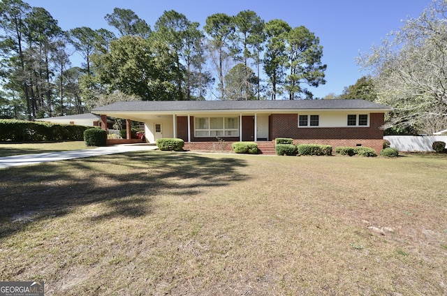 ranch-style house featuring a front yard, concrete driveway, fence, and brick siding