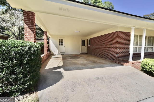 view of patio / terrace featuring an attached carport and driveway