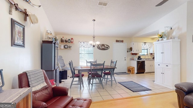 dining room featuring light tile patterned flooring, visible vents, a healthy amount of sunlight, and lofted ceiling