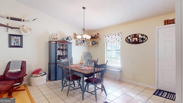 dining area featuring baseboards, light tile patterned floors, a textured ceiling, and an inviting chandelier