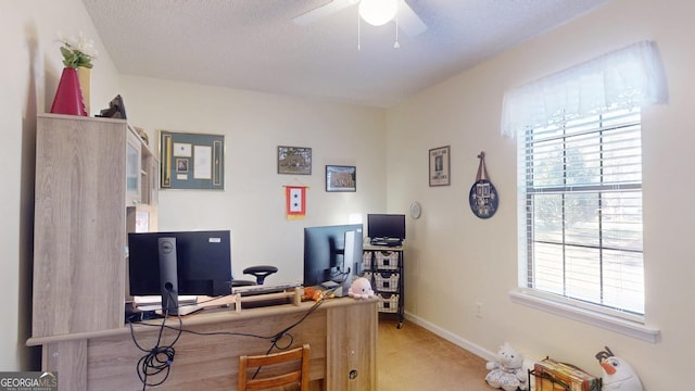 home office with light carpet, baseboards, a textured ceiling, and a ceiling fan