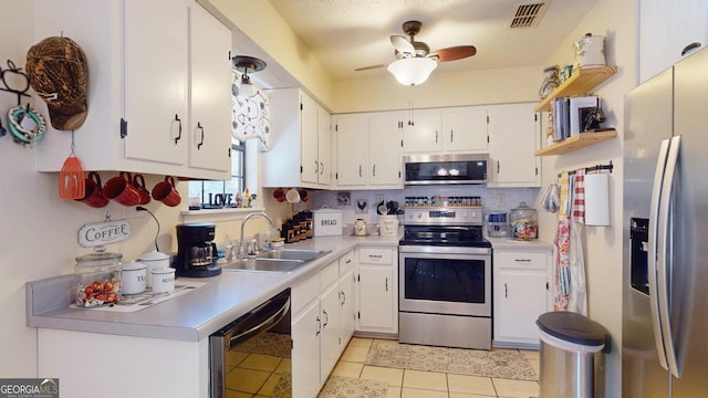 kitchen with visible vents, ceiling fan, light countertops, stainless steel appliances, and a sink