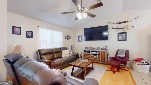 living area featuring light wood-type flooring, ceiling fan, and vaulted ceiling