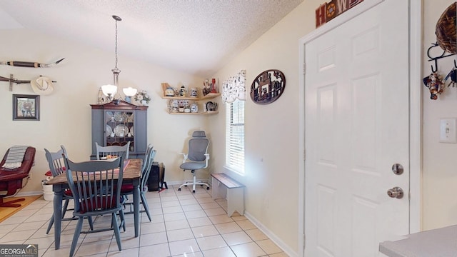 dining room with light tile patterned flooring, a textured ceiling, baseboards, and vaulted ceiling