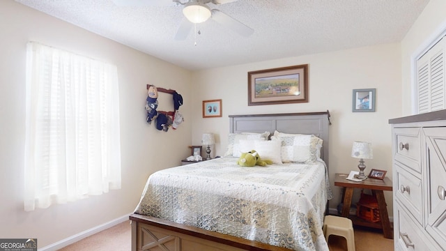 bedroom featuring light carpet, multiple windows, and a textured ceiling