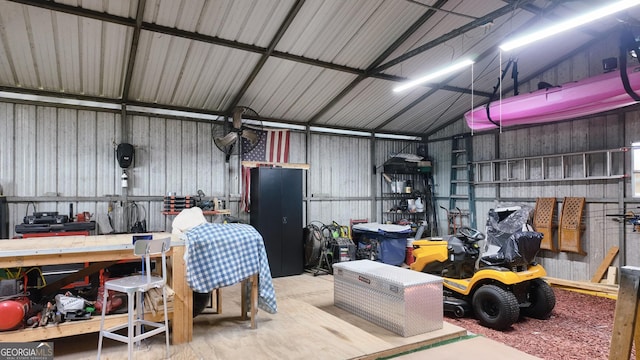 garage featuring a workshop area and metal wall