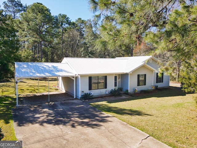 view of front of home featuring a carport, concrete driveway, metal roof, and a front yard