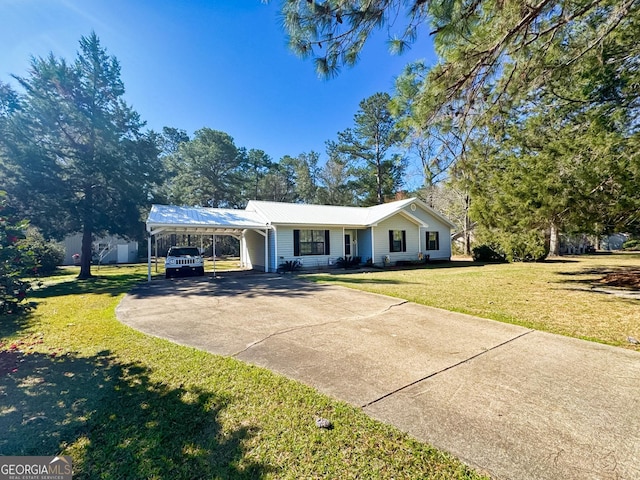 single story home with metal roof, driveway, an attached carport, and a front lawn