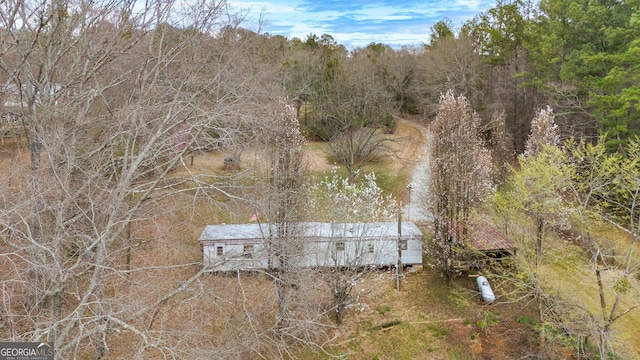 birds eye view of property with a view of trees