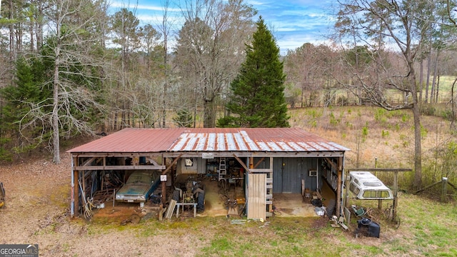 view of front of home with metal roof and an outbuilding