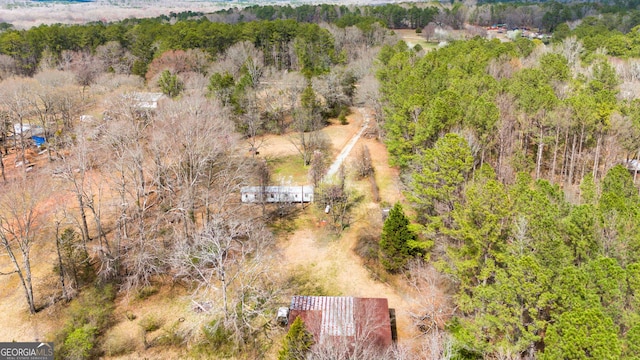 birds eye view of property featuring a forest view