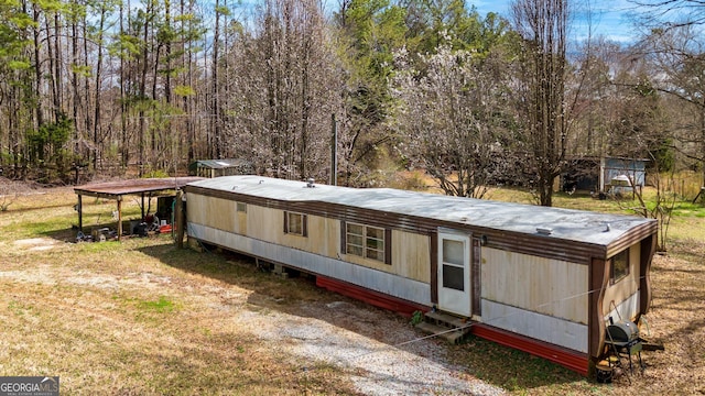 rear view of property featuring a lawn