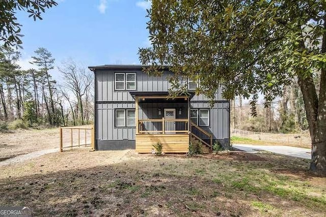 view of front of home featuring fence and board and batten siding