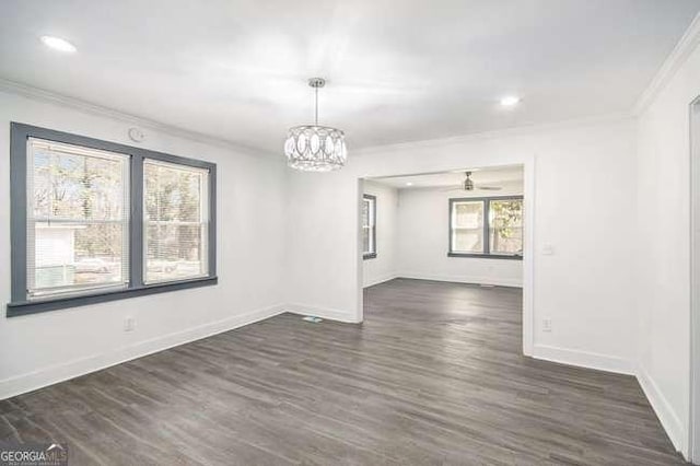 spare room with crown molding, recessed lighting, baseboards, and dark wood-style flooring