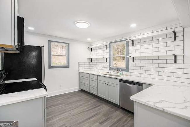 kitchen with decorative backsplash, open shelves, stainless steel dishwasher, and a sink