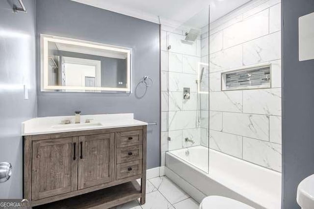 bathroom featuring baseboards, toilet, marble finish floor, vanity, and  shower combination