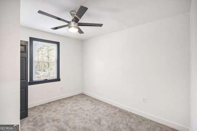 spare room featuring baseboards, ceiling fan, and carpet flooring