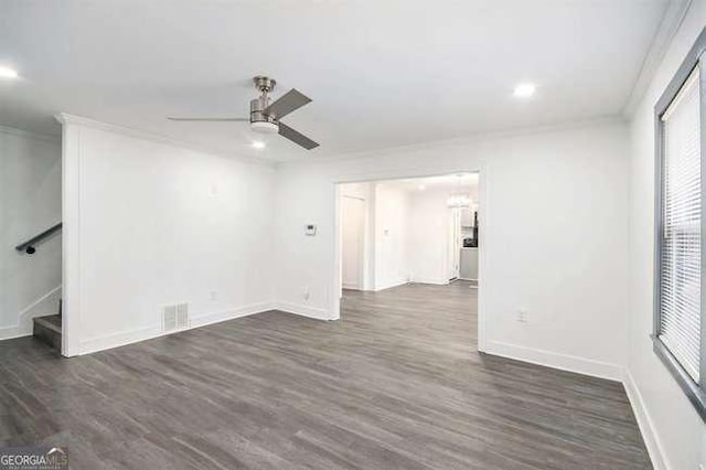 unfurnished room featuring dark wood-style floors, visible vents, ceiling fan, and ornamental molding