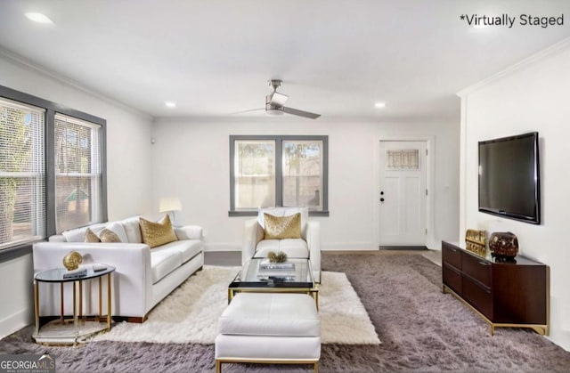 living room featuring ceiling fan, baseboards, ornamental molding, and recessed lighting