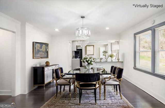 dining room featuring an inviting chandelier, crown molding, wood finished floors, and baseboards