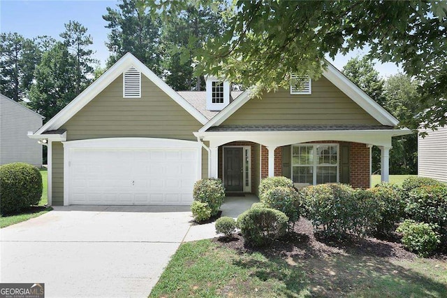 view of front of home with concrete driveway, an attached garage, brick siding, and covered porch