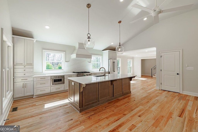 160 Tillman Ln, Athens, GA 30606 - kitchen with custom exhaust hood, light countertops, recessed lighting, high quality fridge, and light wood-style floors