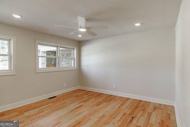 empty room featuring visible vents, baseboards, light wood-type flooring, and ceiling fan